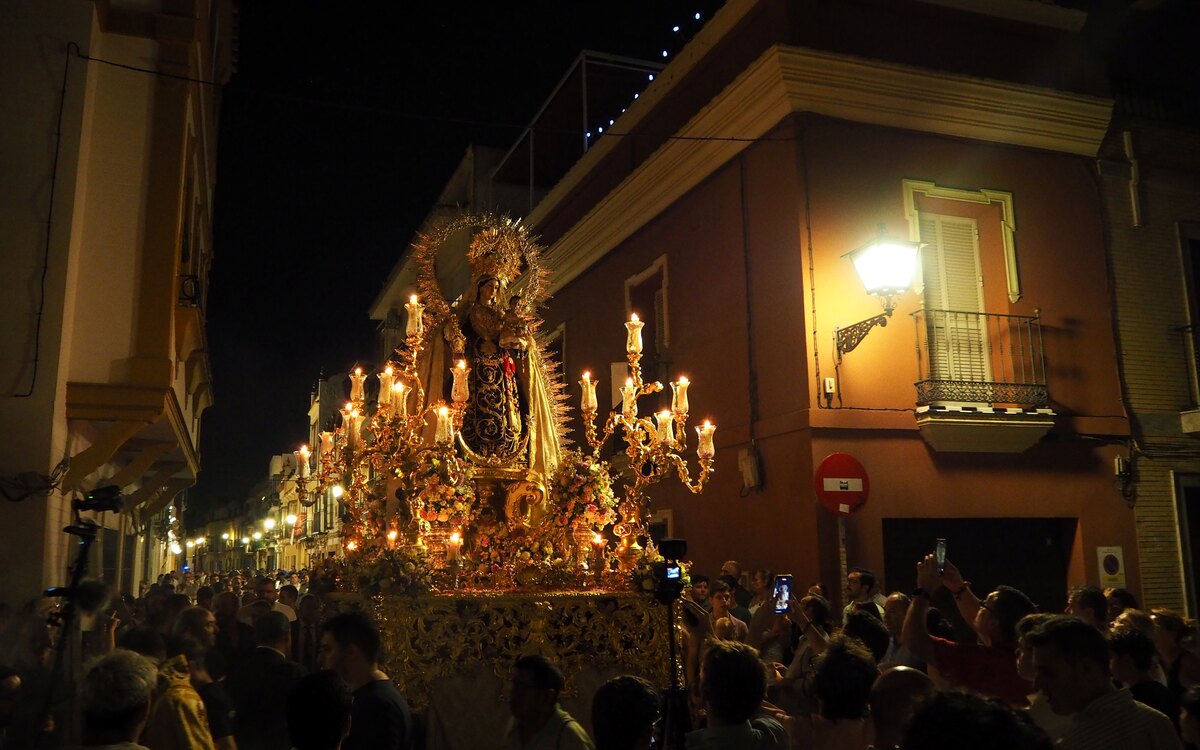 A Holy Week procession with an ornate paso in Seville