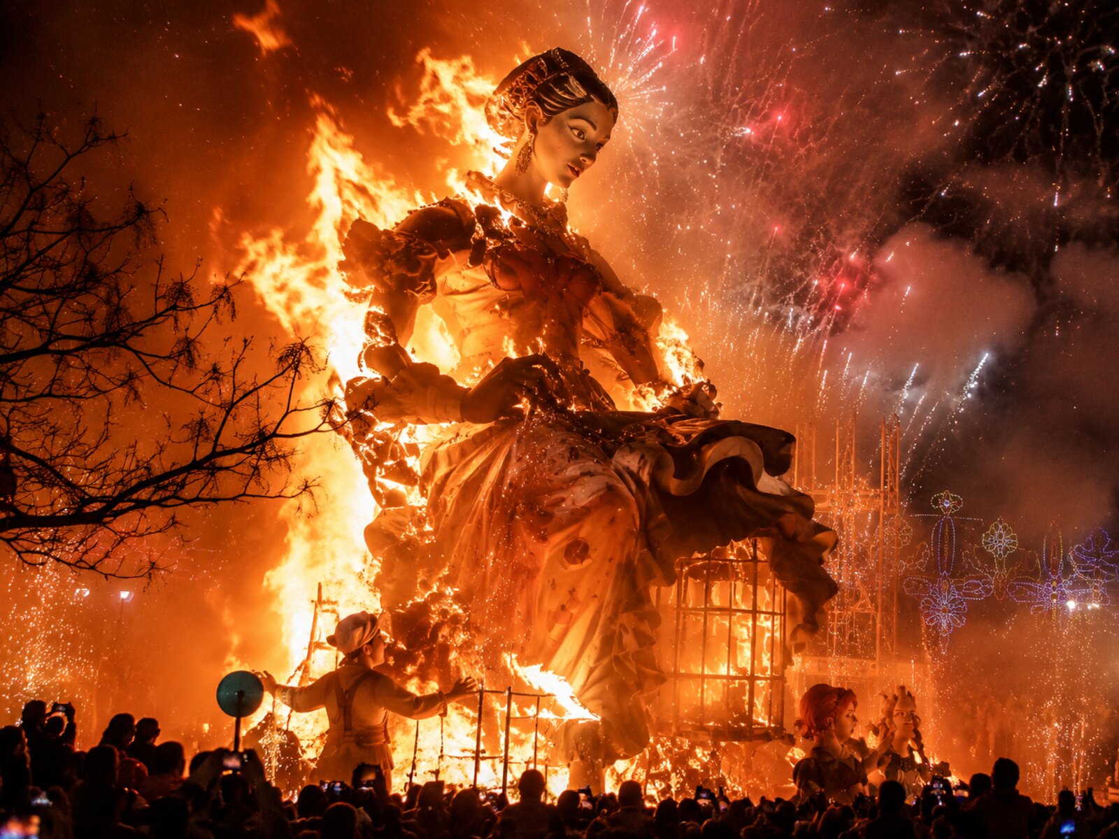Las Fallas in Valencia — a giant Falla figure burning at night against orange flames